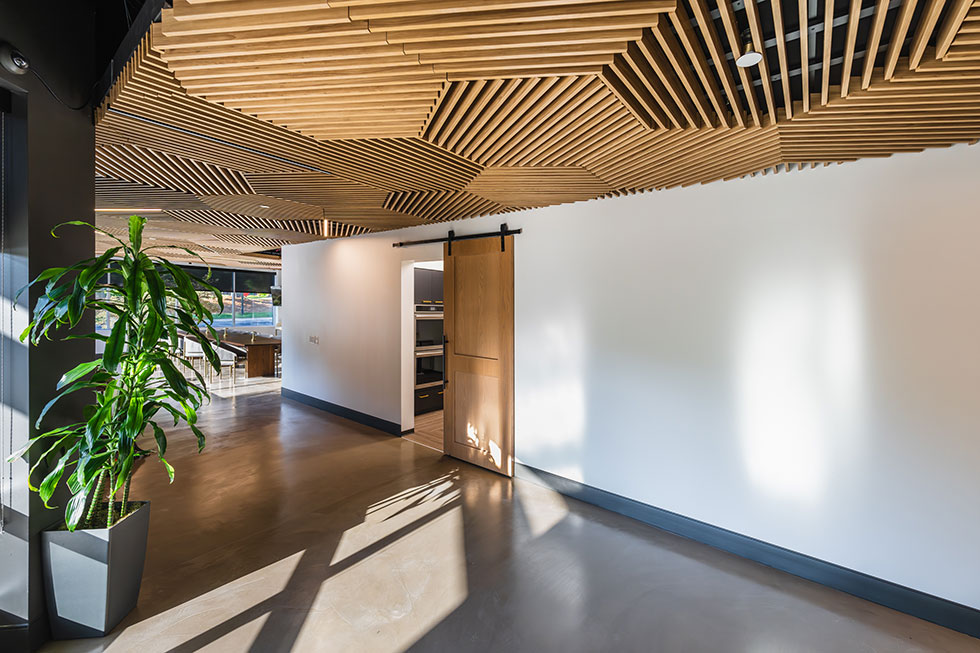 Grille style wood ceiling tiles in hallway