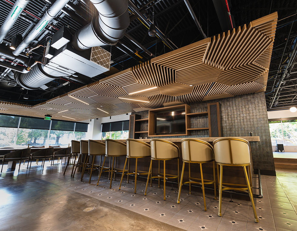 Grille style wood ceiling tiles over bar
