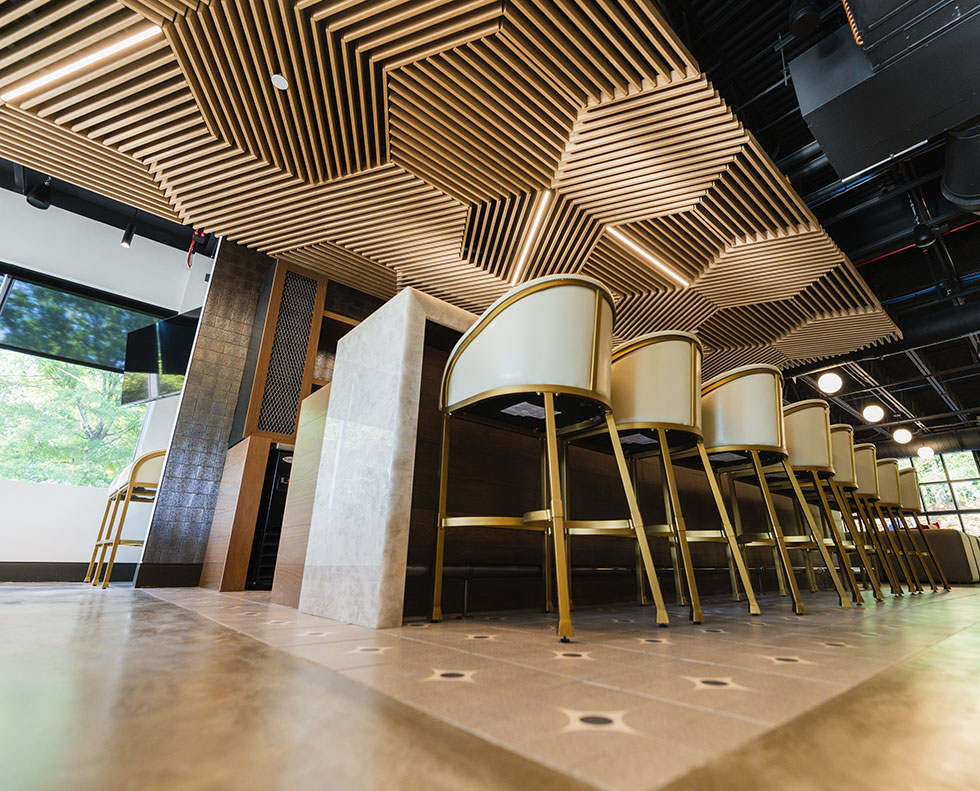 Grille style wood ceiling tiles over bar